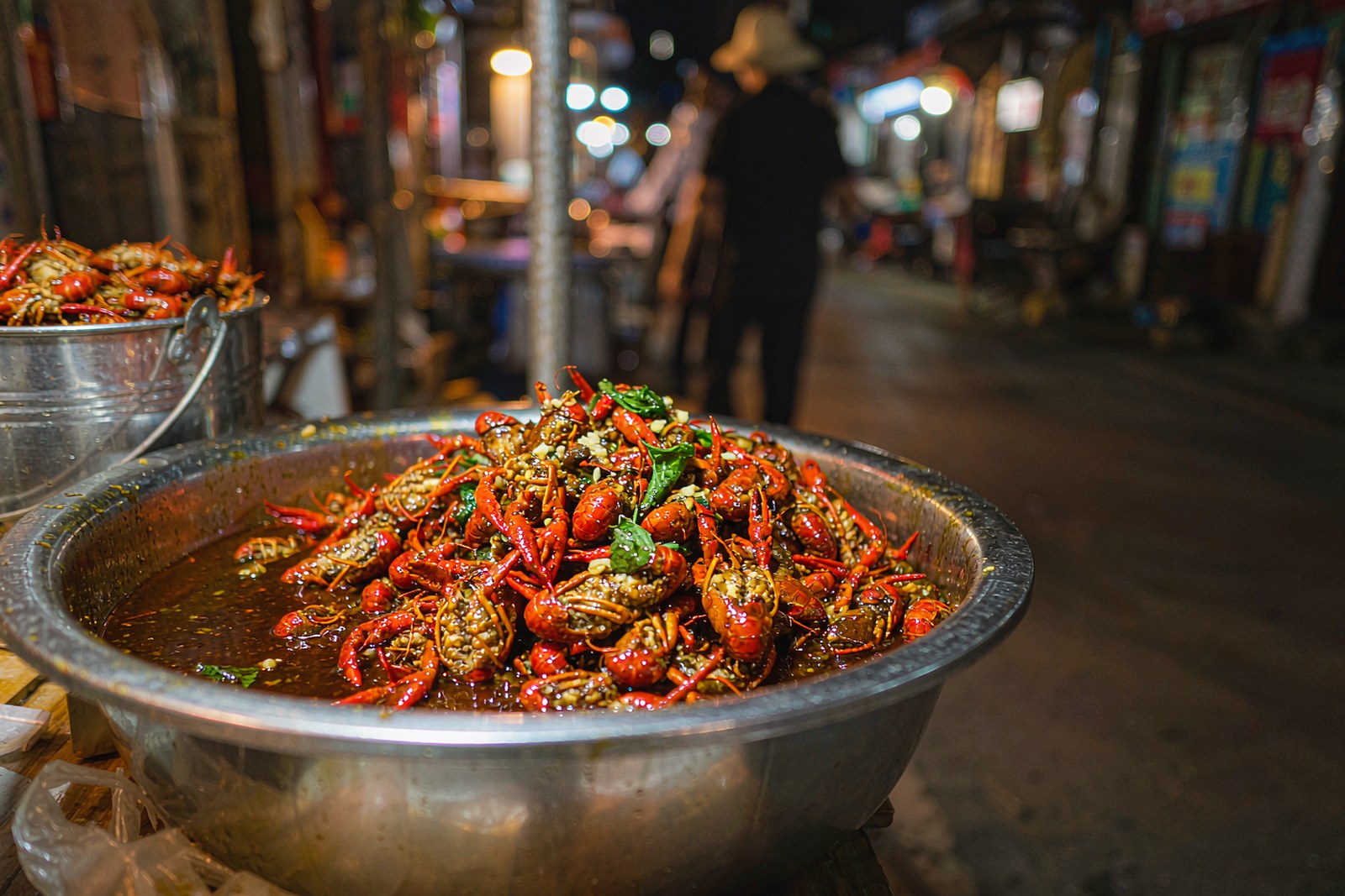 A steel basin of red chilli crayfish with perilla and garlic