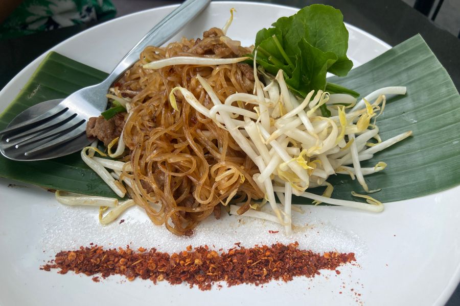 A tangle of glossy noodles glistening with chili oil