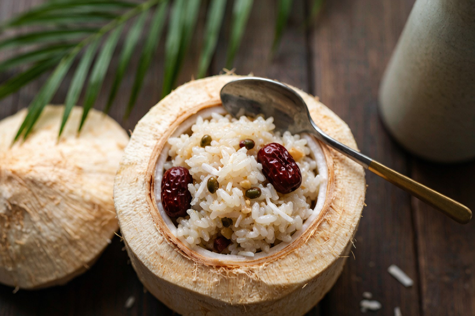 Scooping warm coconut sticky rice from the shell