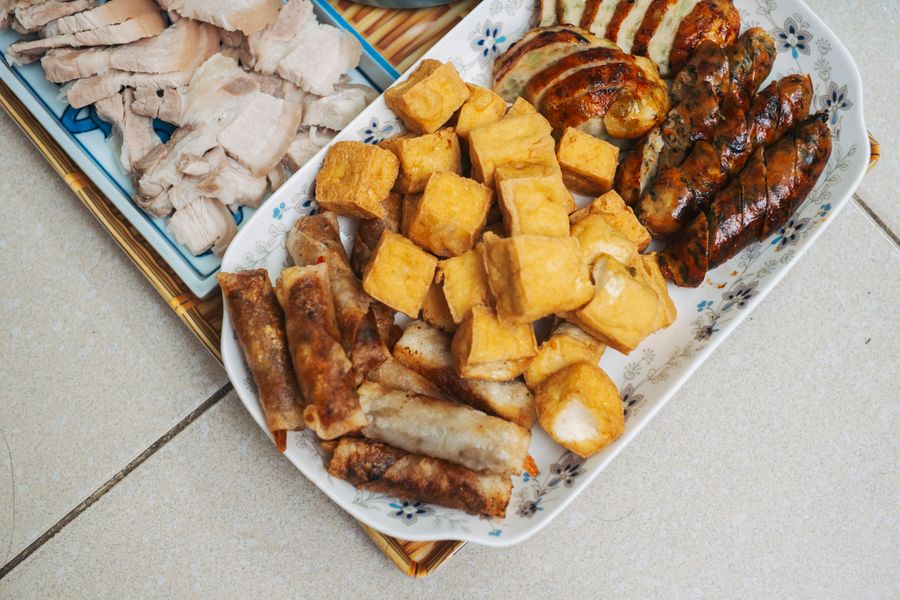 Tofu skewers sizzling on a hot griddle at dusk