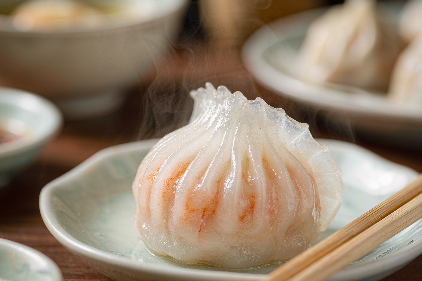 A single har gow dumpling with fine pleats and shrimp