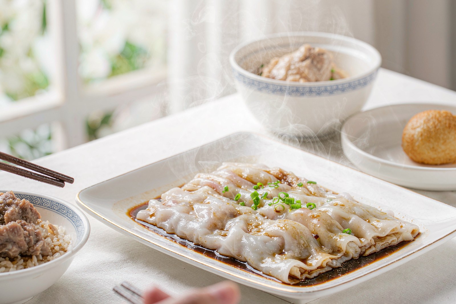 Fresh steamed rice noodle rolls with soy and scallions