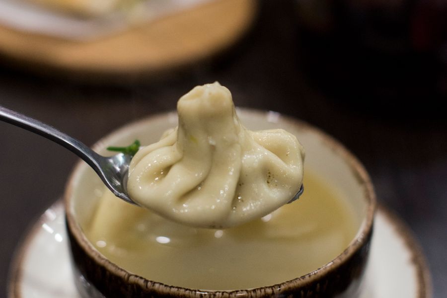 Soup dumplings resting in a bamboo steamer