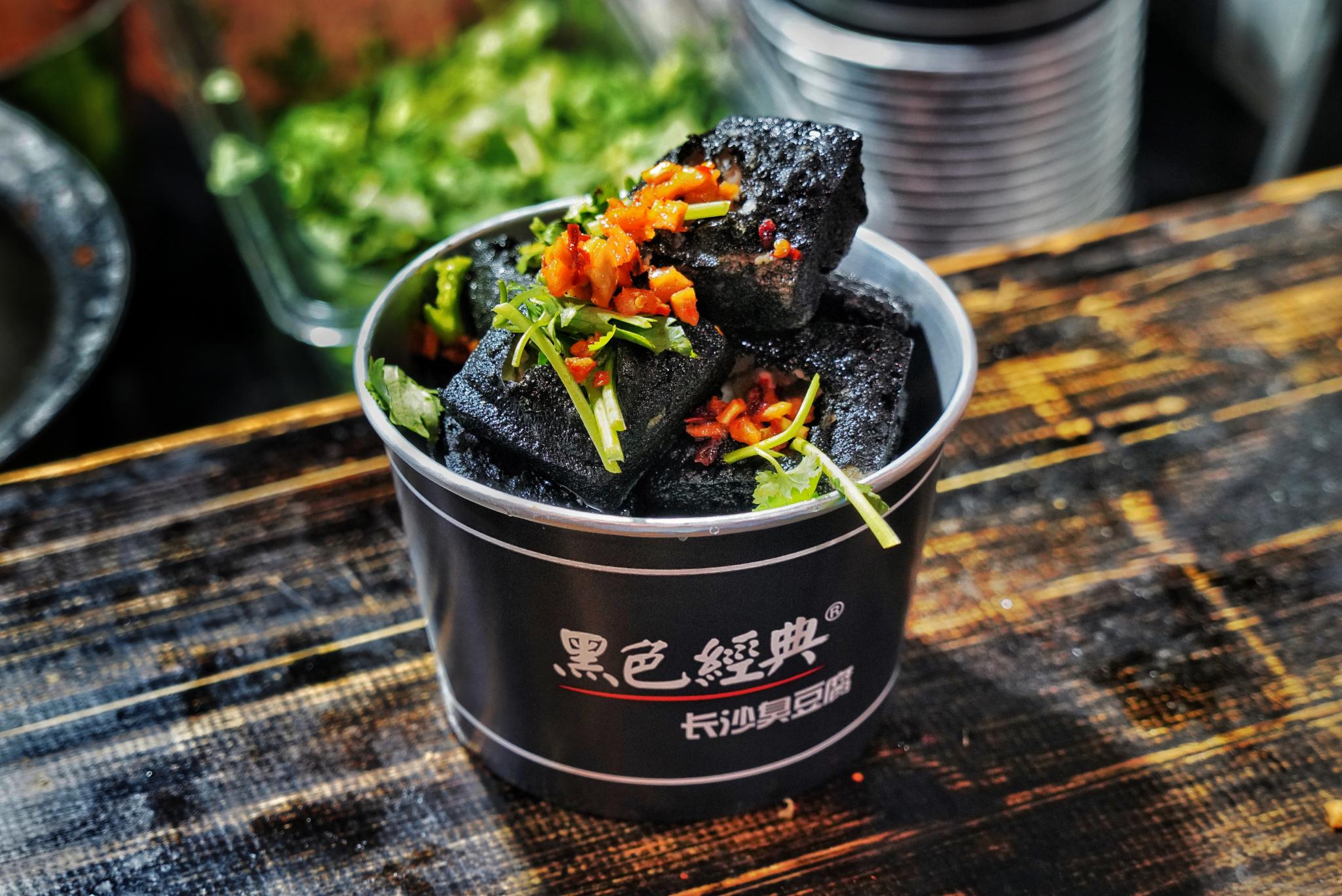 Charcoal-black cubes waiting at the fryer