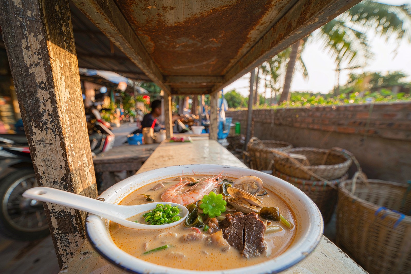 A bowl of milky sour rice-vinegar broth with shrimp, clams and sea vegetable