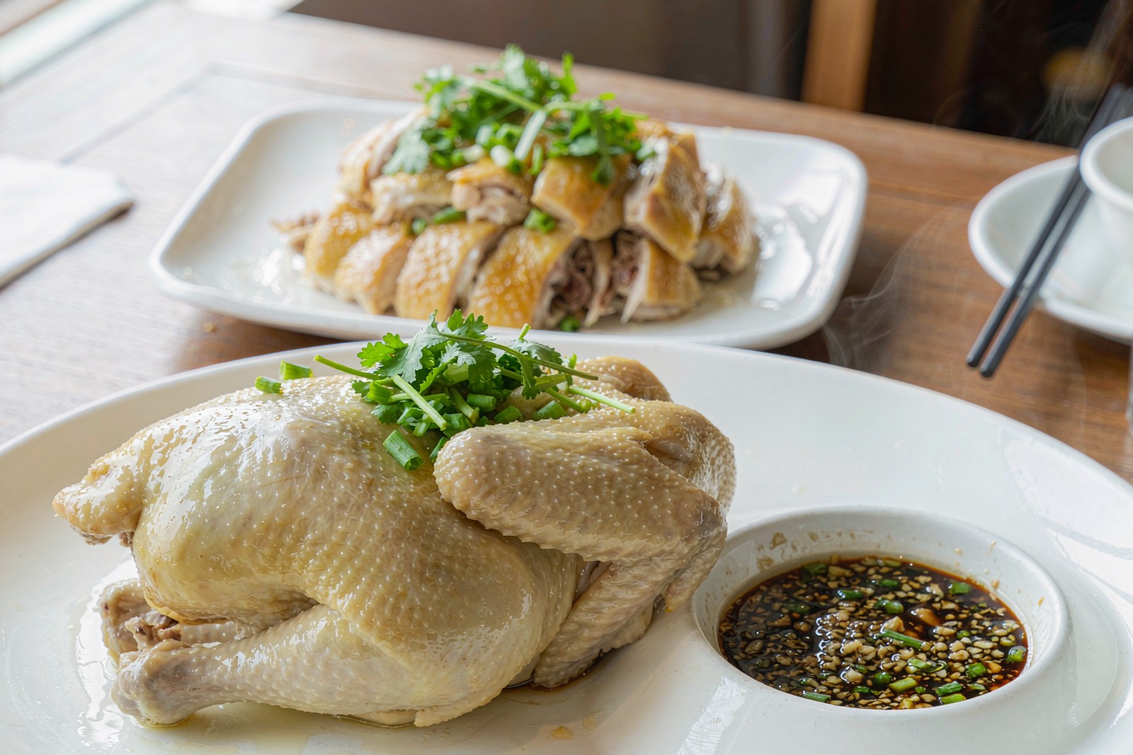 A glistening poached white-cut chicken with scallion-ginger sauce