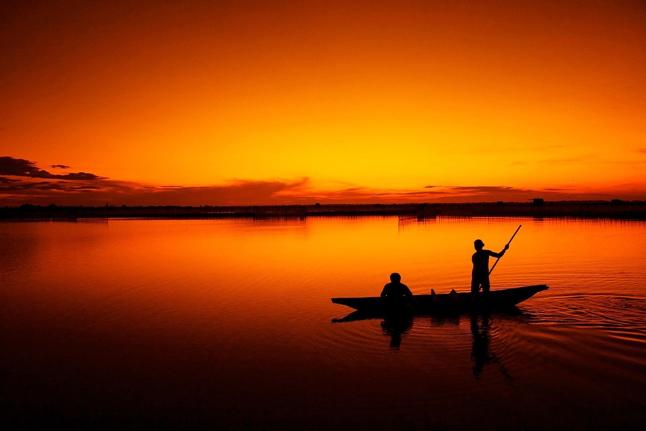A fishing boat moored in the morning light off the lake