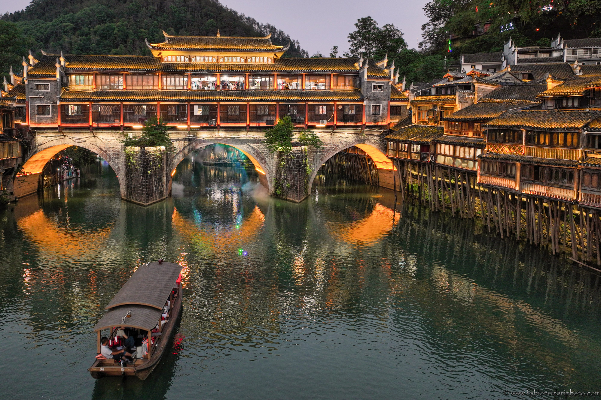 A wooden guesthouse built on stilts over the river