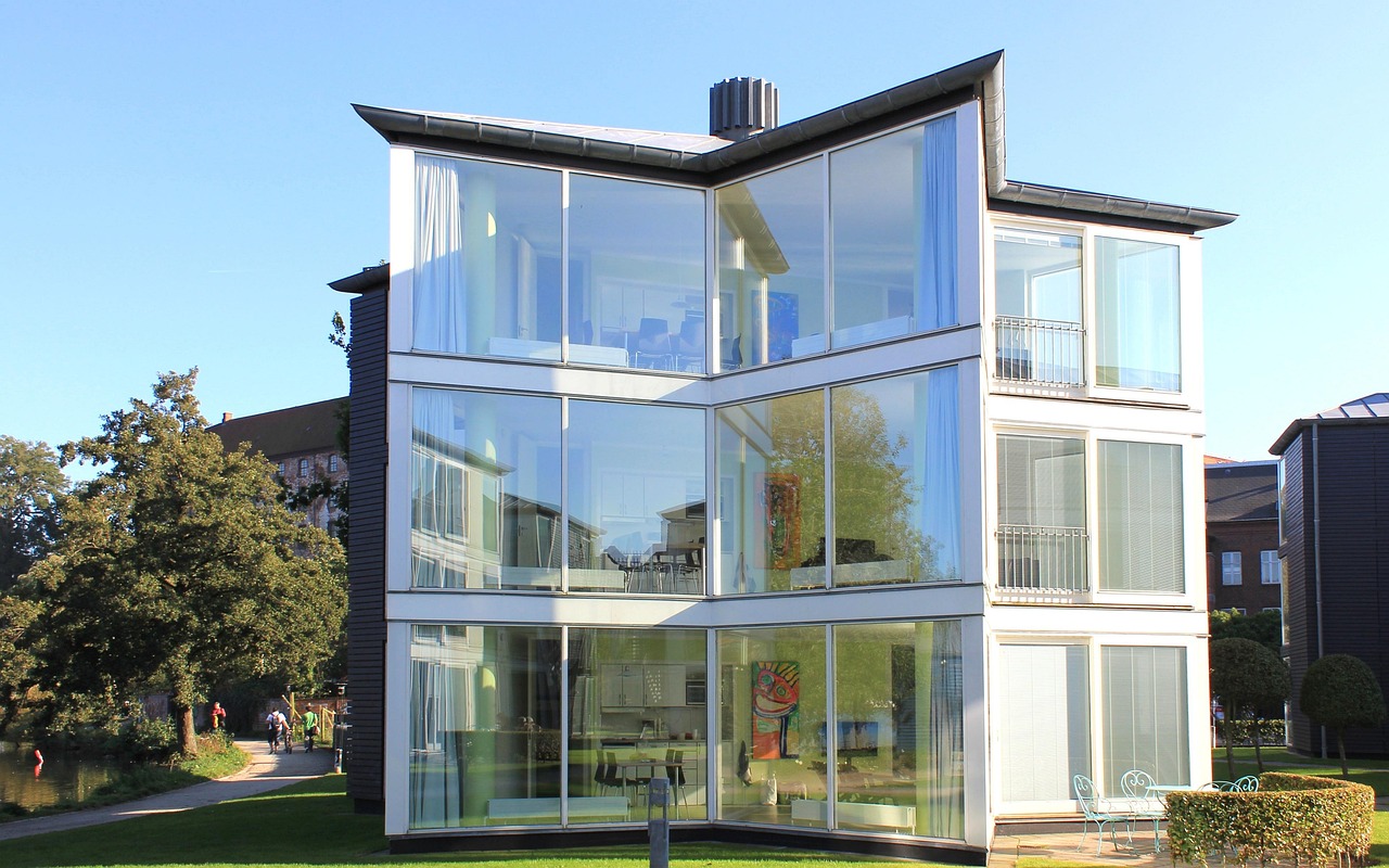 A glass-walled house suspended above a gaping canyon