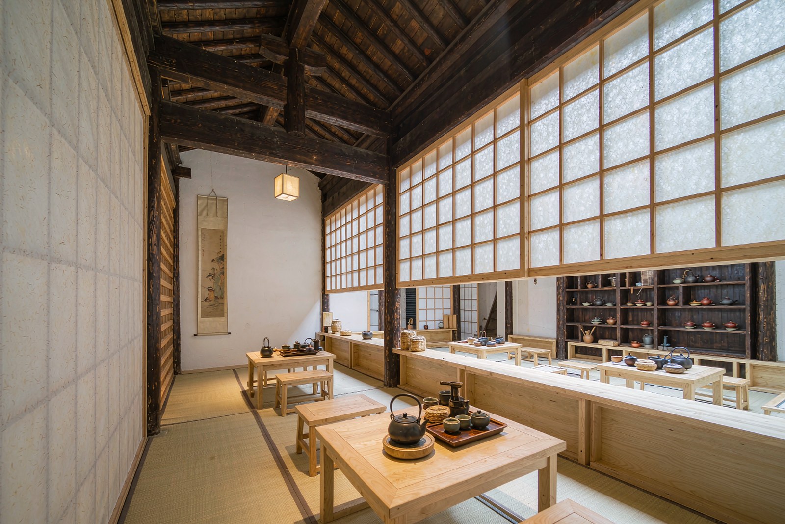 A tea room in the old Chinese style, low table and shelves of teaware