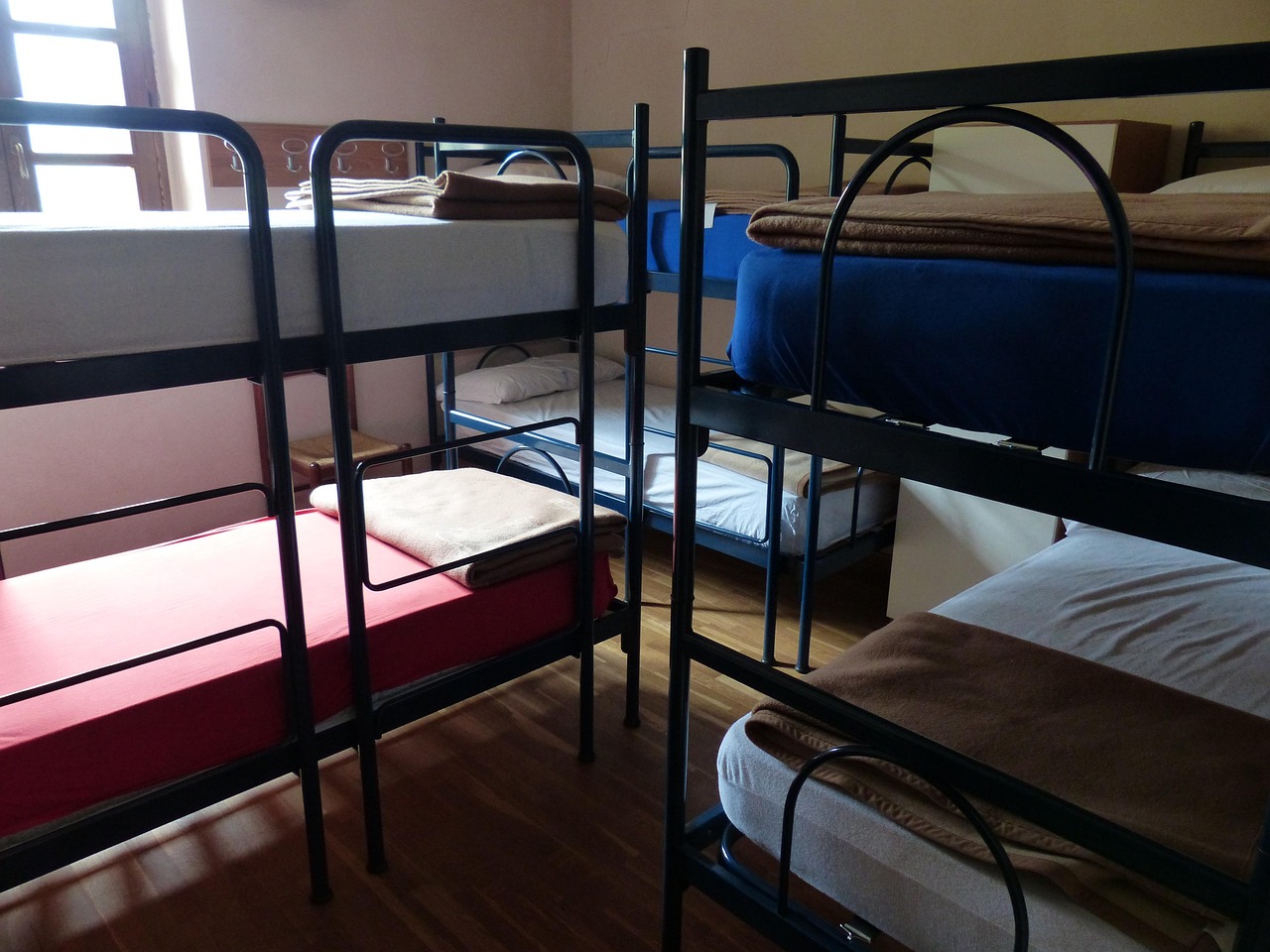 Rows of bunk beds in a clean, light-filled dormitory