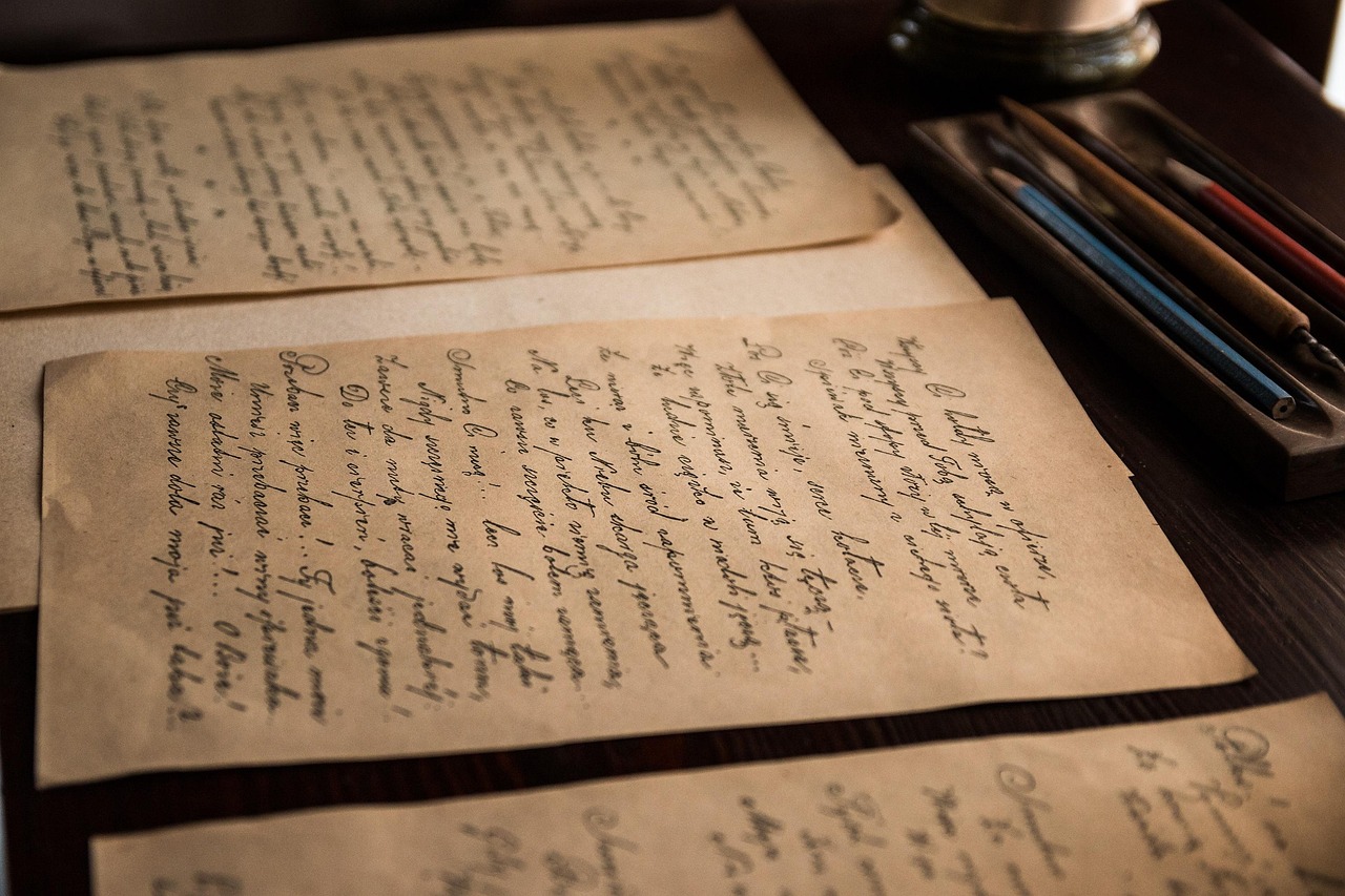 Old envelopes and blank pages left on a wooden writing desk