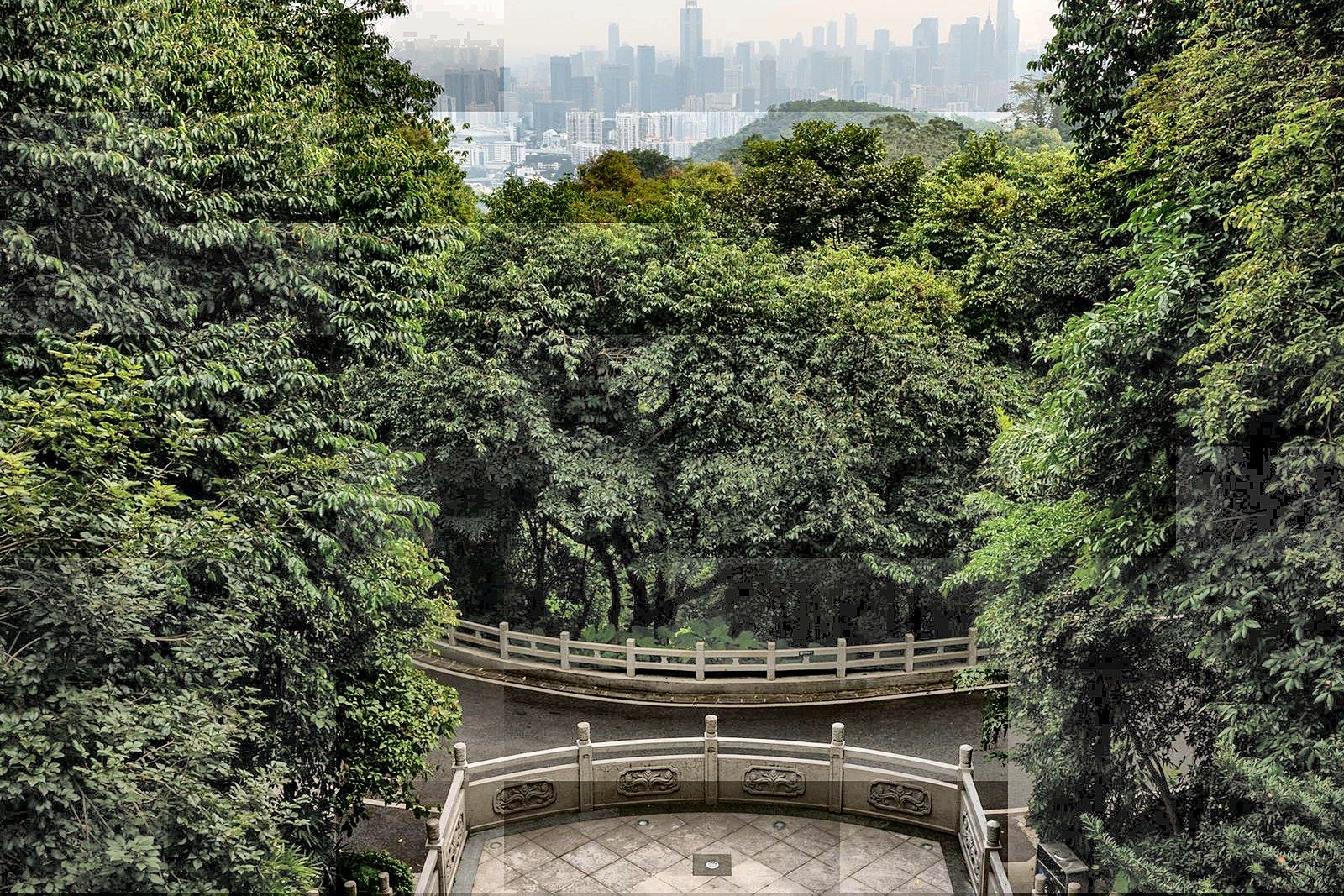 Looking out over the green hills of Baiyun Mountain towards the Guangzhou skyline