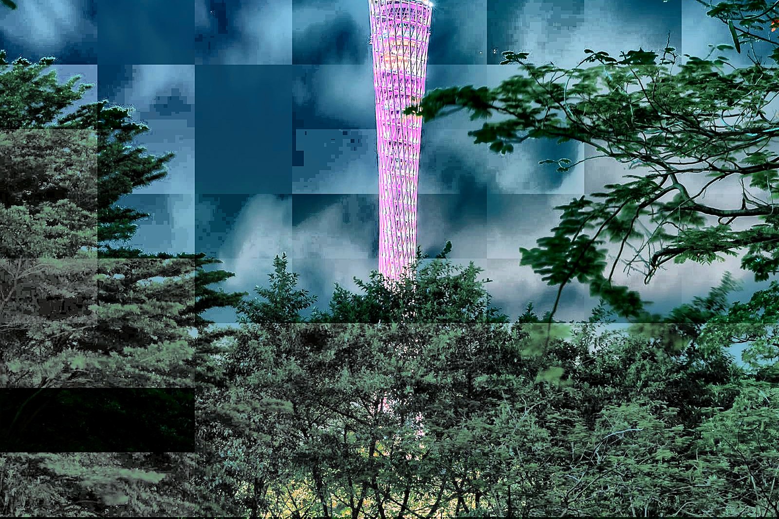 Canton Tower lit up at night above the Pearl River bridges