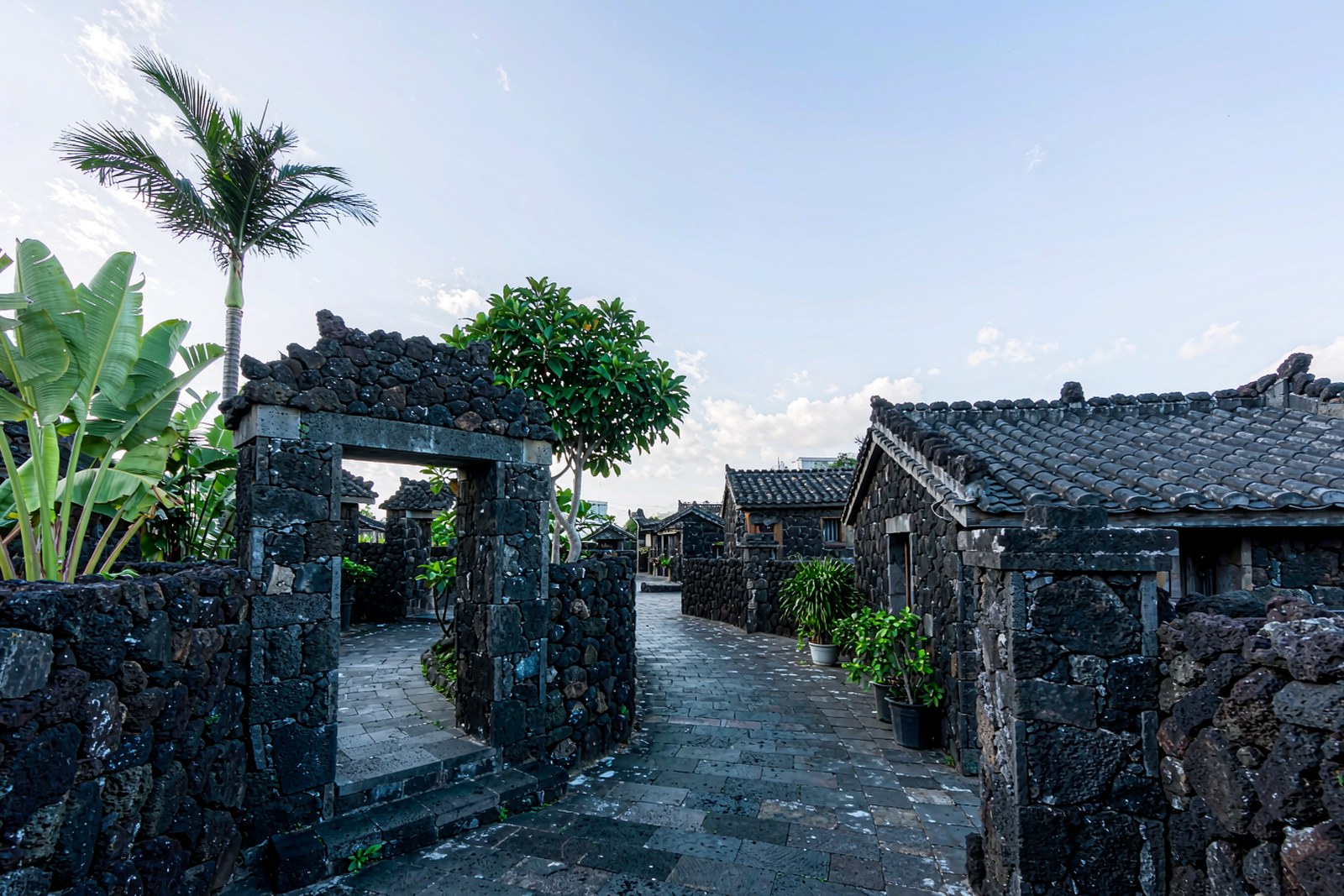 A village lane built of black volcanic stone with a stone gateway