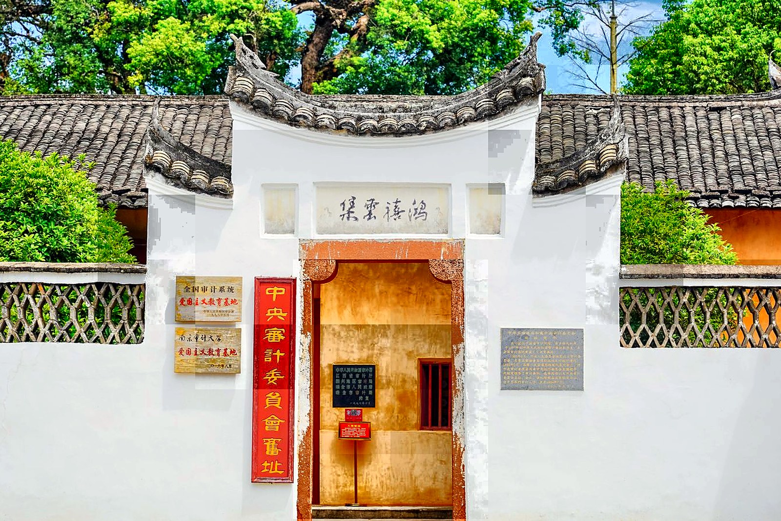 A cluster of Kaiping diaolou towers among the fields, blending Chinese and Western styles