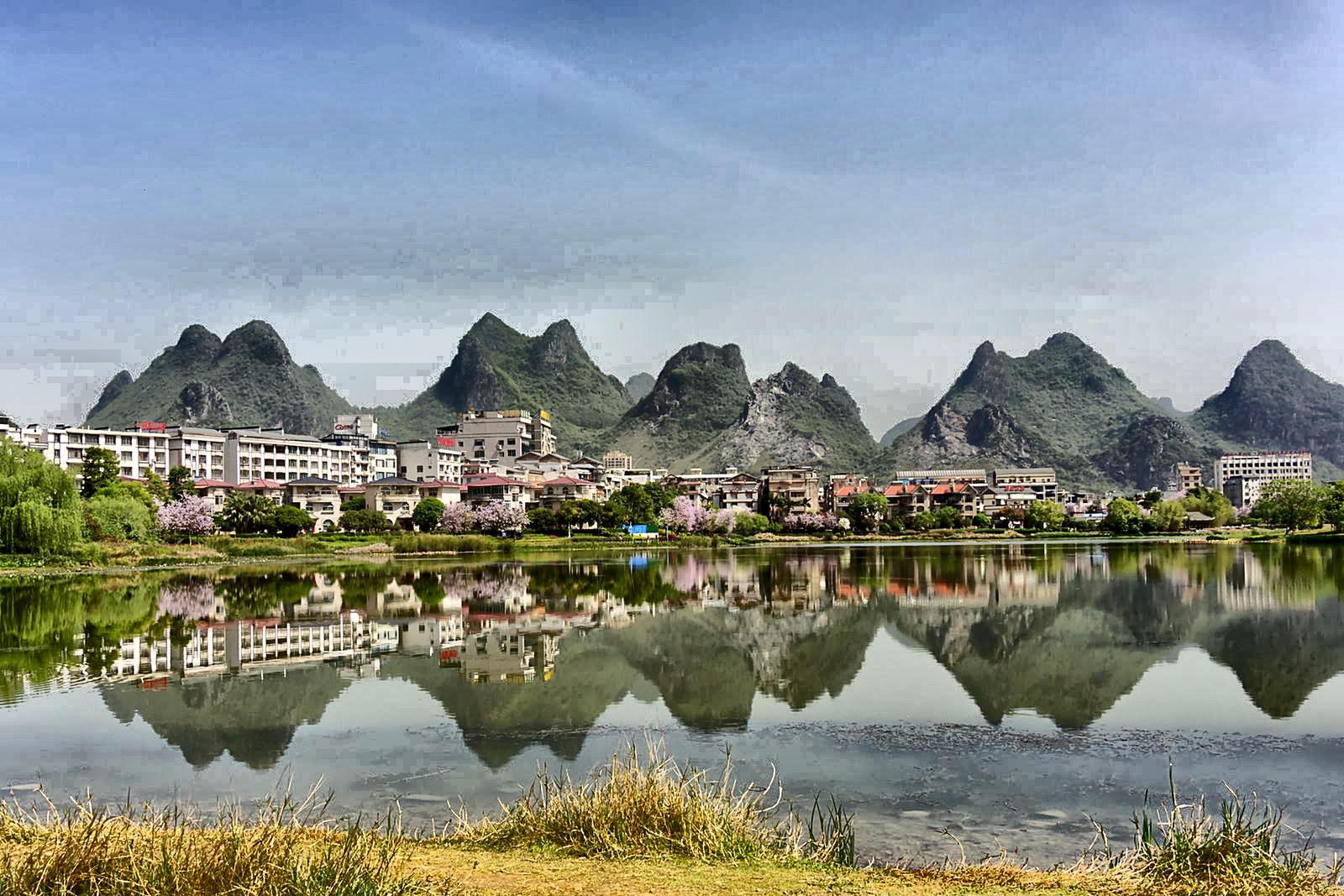 Seven limestone peaks reflected in a still lake at Seven Star Crags